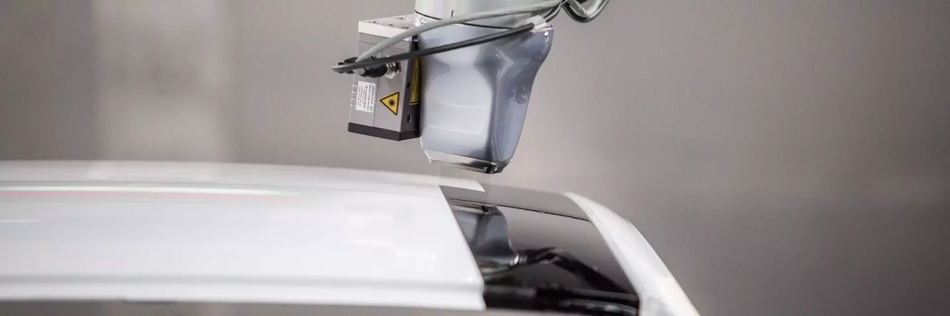 View of EcoPaintjet spraying the surface of a car body