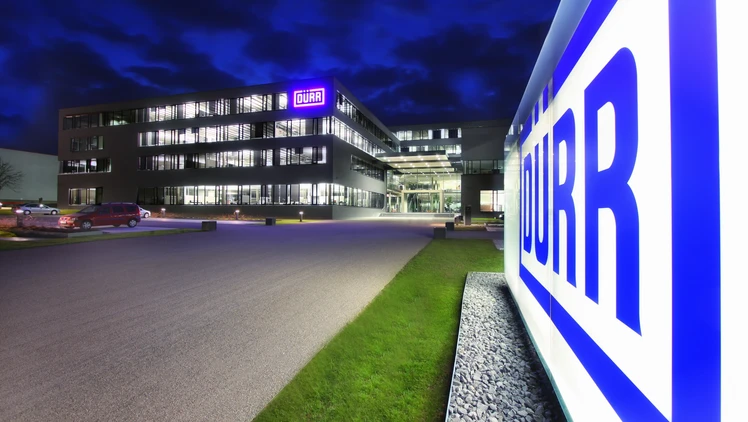 Dürr location headquarters in germany at night viewing the shining logo in the front of the building.