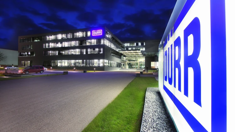 Dürr location headquarters in germany at night viewing the shining logo in the front of the building.