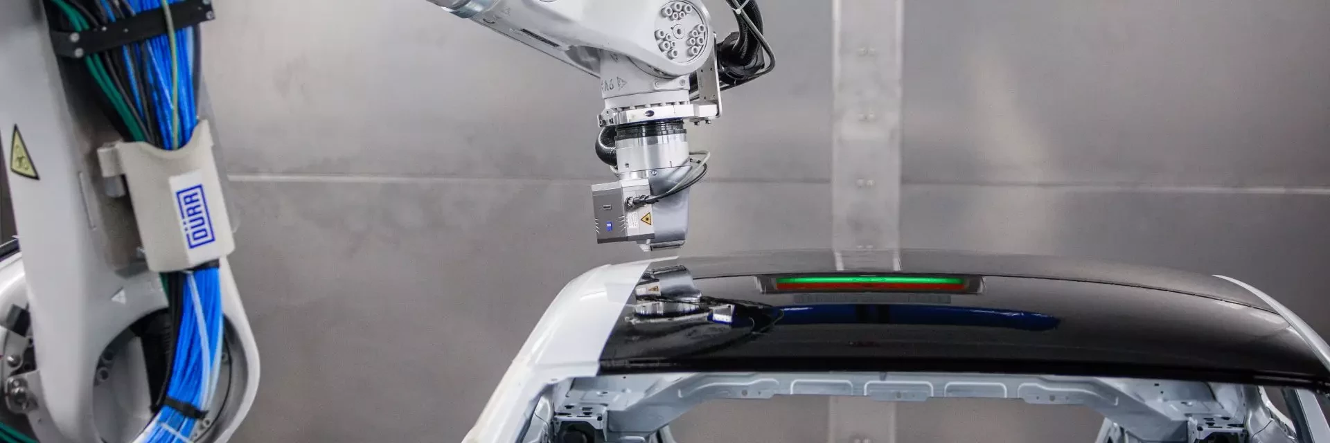 EcoPaintjet sprays on car body from the side